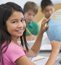 Student in class pointing at globe