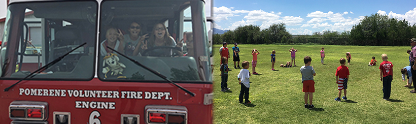 Students in a pomerene volunteer fire department firetruck and students on a field