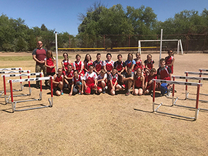 Track and field team pose on the field