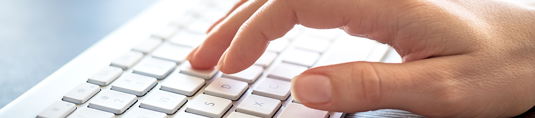 Fingers typing on a computer keyboard