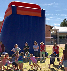 Students play tug of war outside