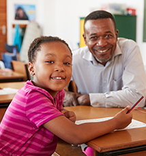 Teacher and elementary school girl smiling